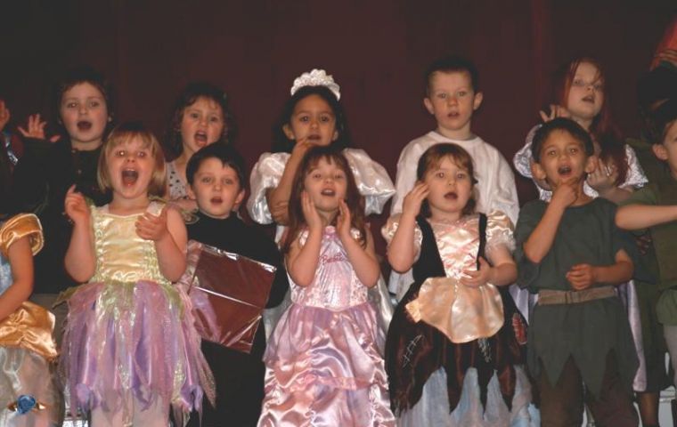 Pre-school children enthusiastically sing - and sign - a musical number
